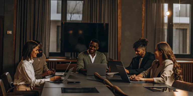 Property management team reviewing marketing plans and budget spreadsheets in a modern office