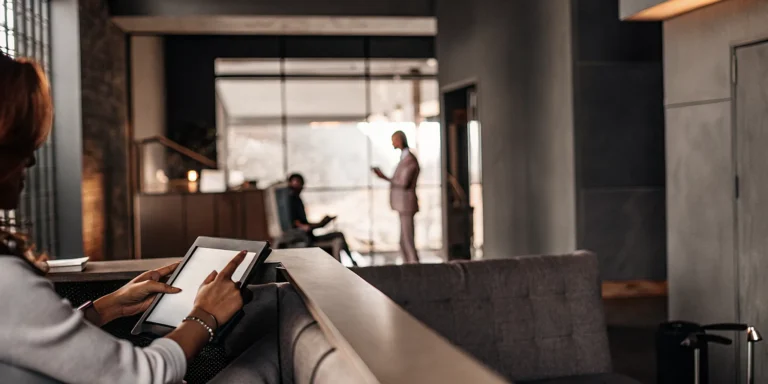 Property management professional reviewing data on a tablet in a modern apartment leasing office