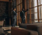Asset manager and investor reviewing commercial portfolio performance in a modern office lobby {{brizy_dc_image_alt entityId=