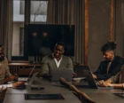 Property management team reviewing marketing plans and budget spreadsheets in a modern office {{brizy_dc_image_alt entityId=