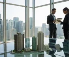 Professionals discussing a strategic property management plan with building models in an office. {{brizy_dc_image_alt entityId=